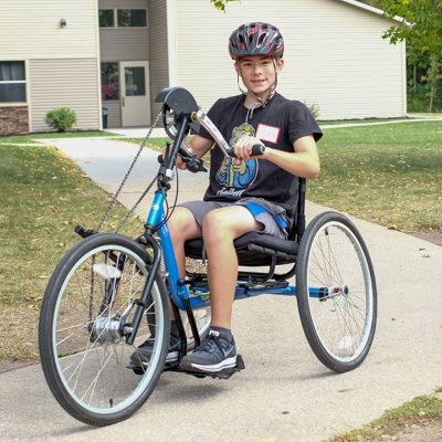 Boy pedaling hand cycle